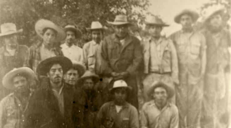 14 men stainding in a field