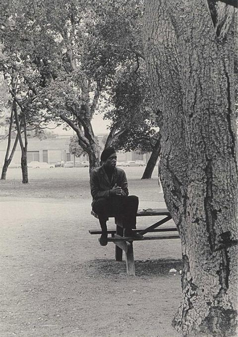 A man sits on a picnic table.