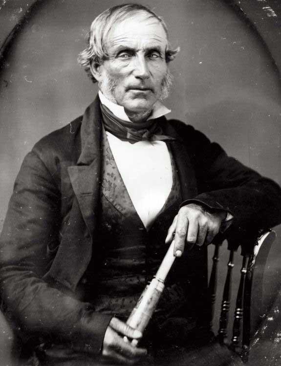 Portrait of a man sitting in a chair.