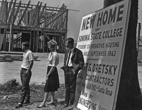 3 people looking at the construction of a Sonoma State building.