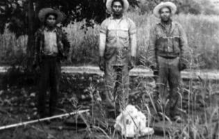 3 men in a field.