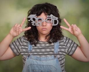 Woman with glasses that spell Grad