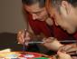 2 men adding sand to the mandala.