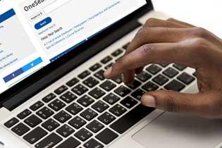 Closeup of a hand typing on a keyboard