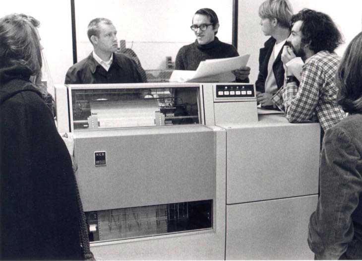 Students surrounding a large computer.